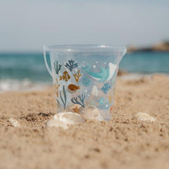 Little Dutch Beach Bucket Ocean Dreams Blue on the sand with shells