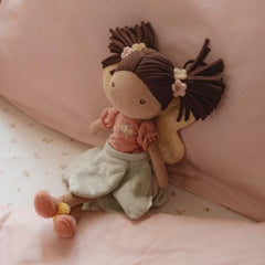 Little Dutch Fairy Doll Evi lying on a pink bed