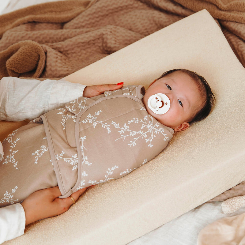 Baby lying on the Meyco Soft Sand terry changing pad cover