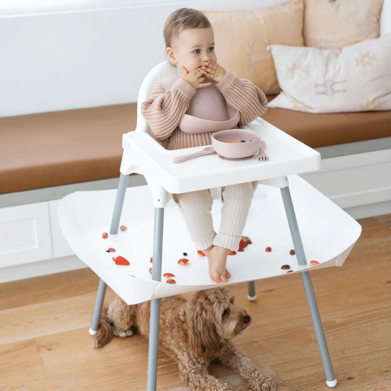 Baby eating in an IKEA Antilop high chair with a White Catchy food catcher