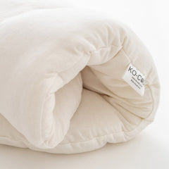 Ko-Coon merino Moses mattress rolled to show thickness
