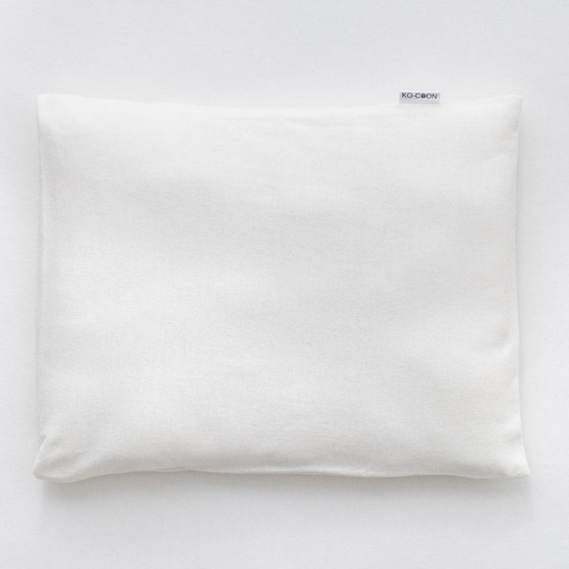 Ko-Coon milky white baby pillowcase on a merino pillow